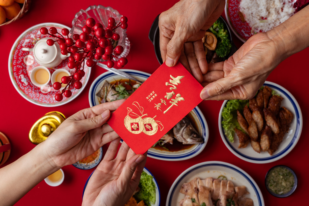 Grandparent Giving Ang Pao to Grandchild